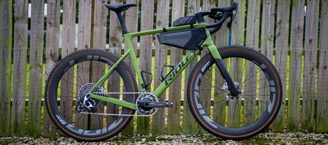 Detail photo of a green Ridley ASTR RS leaning against a wooden fence