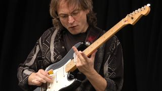 Sonny Landreth playing slide guitar using a Black Fender Stratocaster