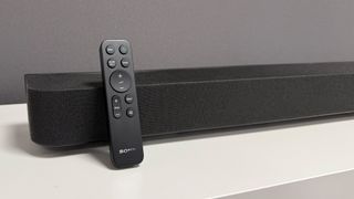 Sony Bravia Theatre Bar 8 soundbar on white surface with remote propped against it