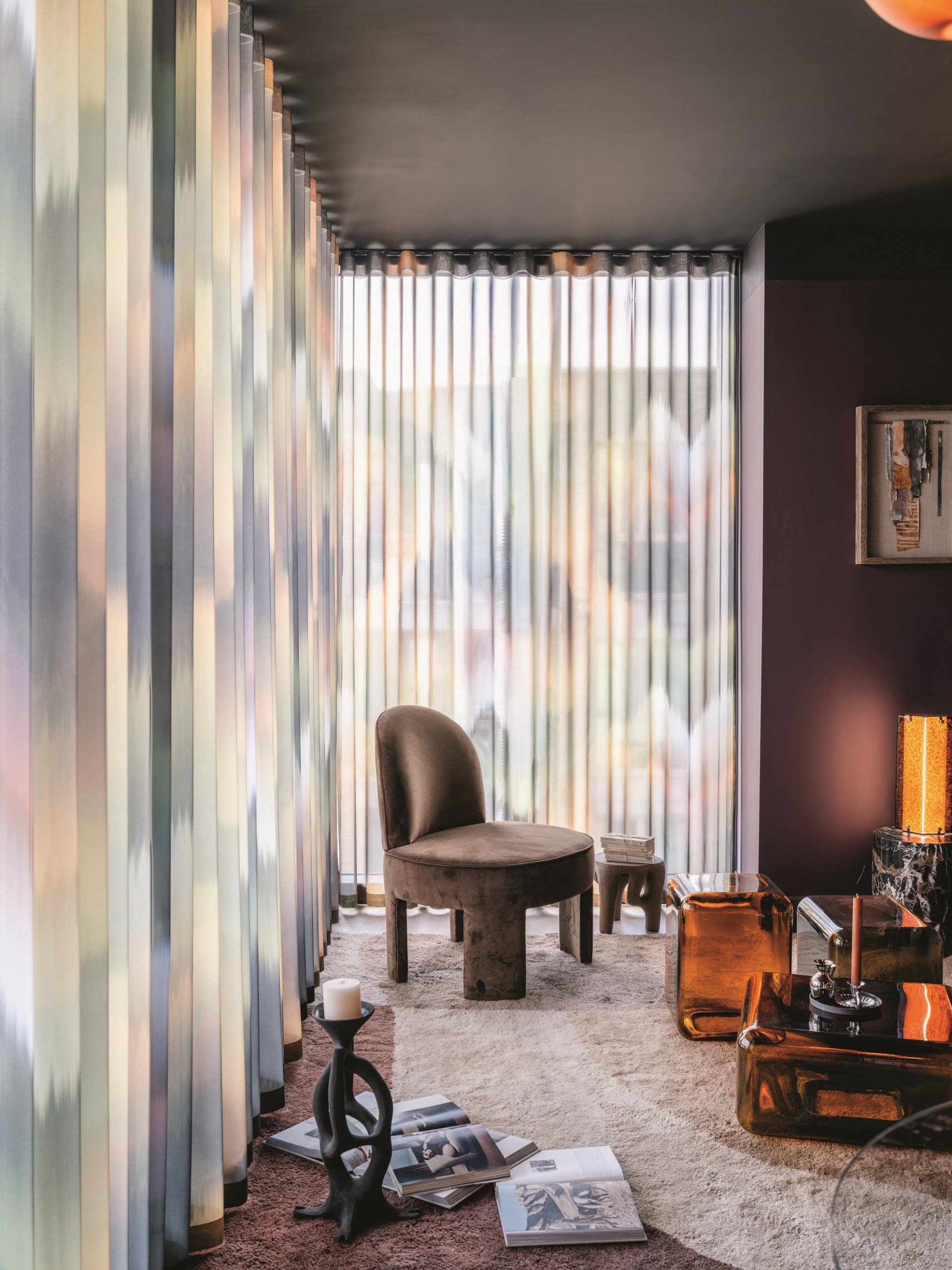 tie-dye sheer curtains in a living room with purple wall, gray ceiling, rug, with brown armchair, and orange glass side table