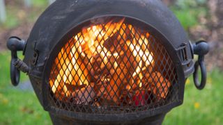 cast iron chiminea with fire in it