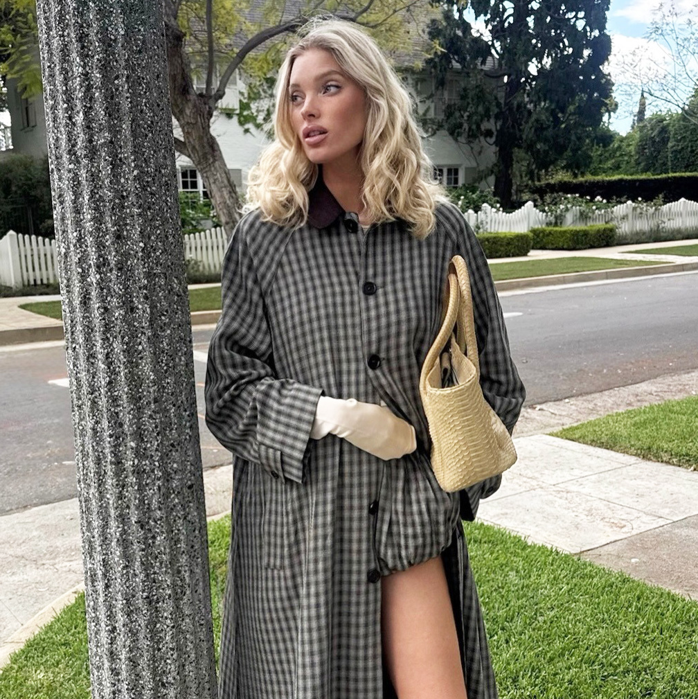 Elsa Hosk wearing a Helsa trench and shorts with a Chanel tote and Comme Si Yves Socks in Khaki