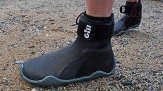 Person's feet wearing Gill Marine Edge boots