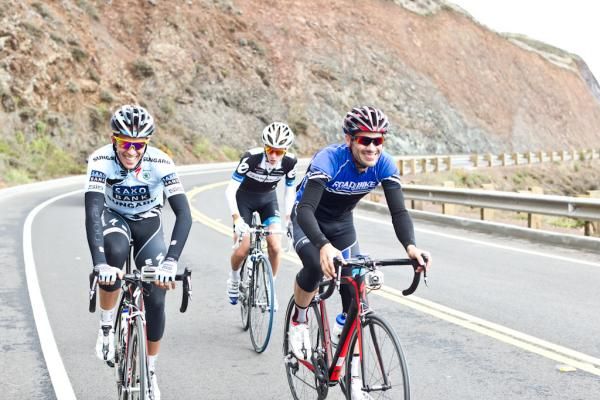 Alberto Contador shares a joke with a rider.