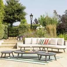 Habitat Santorini 6 Seater Rattan Effect Garden Sofa Set on a patio