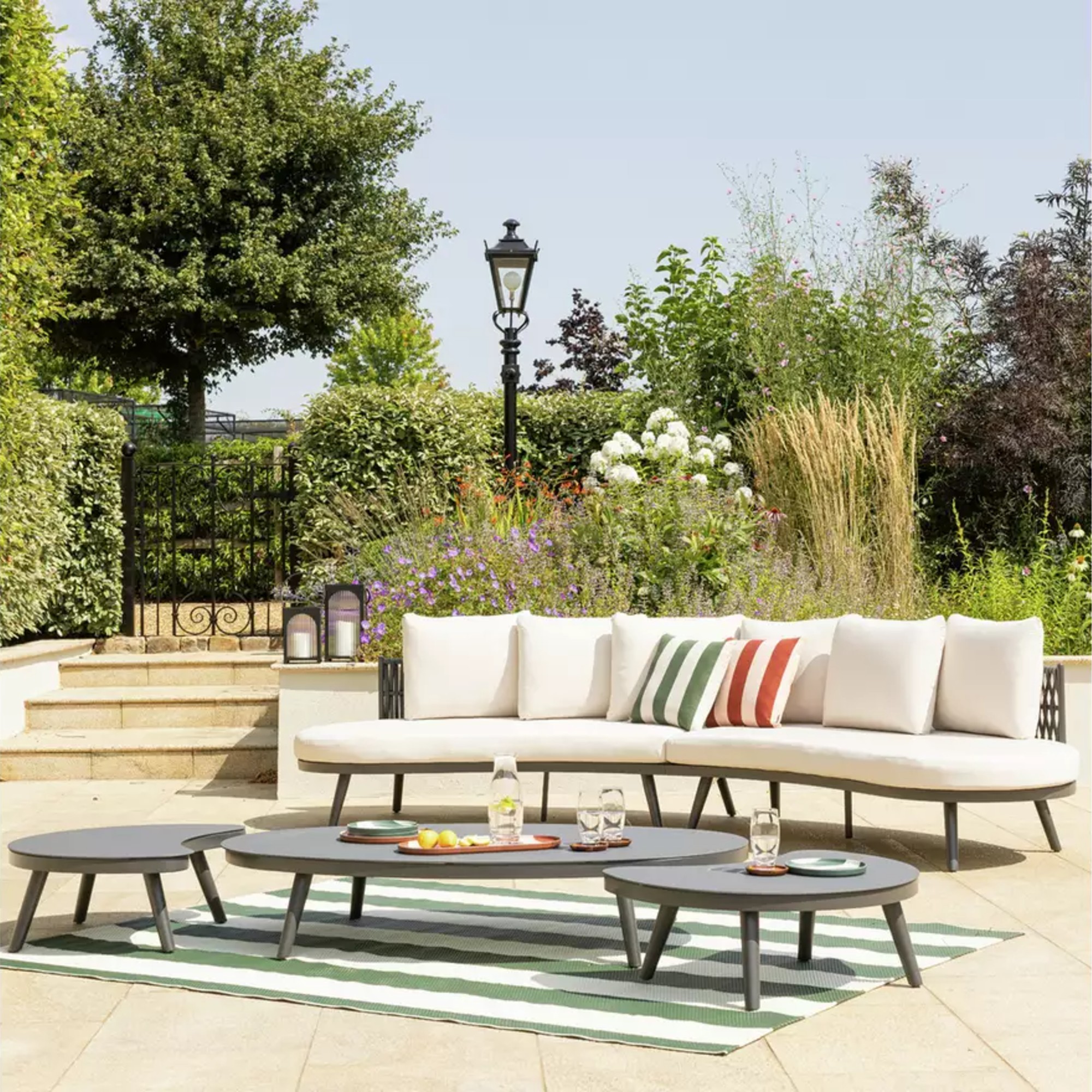 Habitat Santorini 6 Seater Rattan Effect Garden Sofa Set on a patio