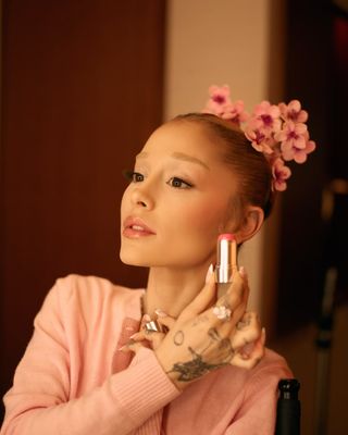 A photo of the singer showing off her honey blonde bun topped with a sakura flower crown.