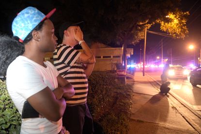Jermaine Towns and Brandon Shuford wait down the street from a shooting at Pulse Nightclub in Orlando