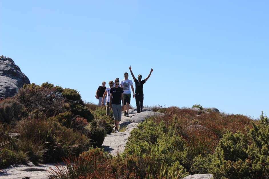 A second group of riders reach the top