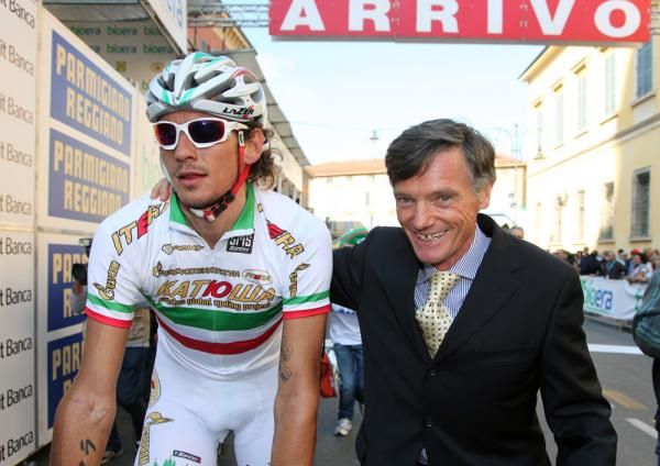 Pozzato is guided to the podium after his win.