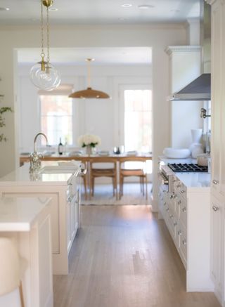 a kitchen with a dining table in the background