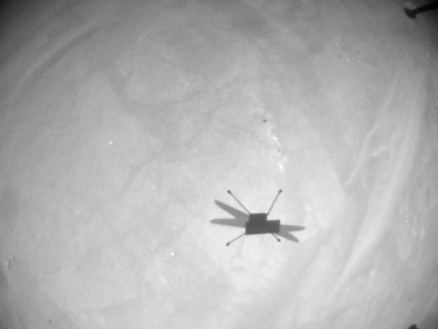 A photograph of the Ingenuity helicopter&#039;s shadow on the Martian surface captured during the chopper&#039;s 16th flight, on Nov. 21, 2021.