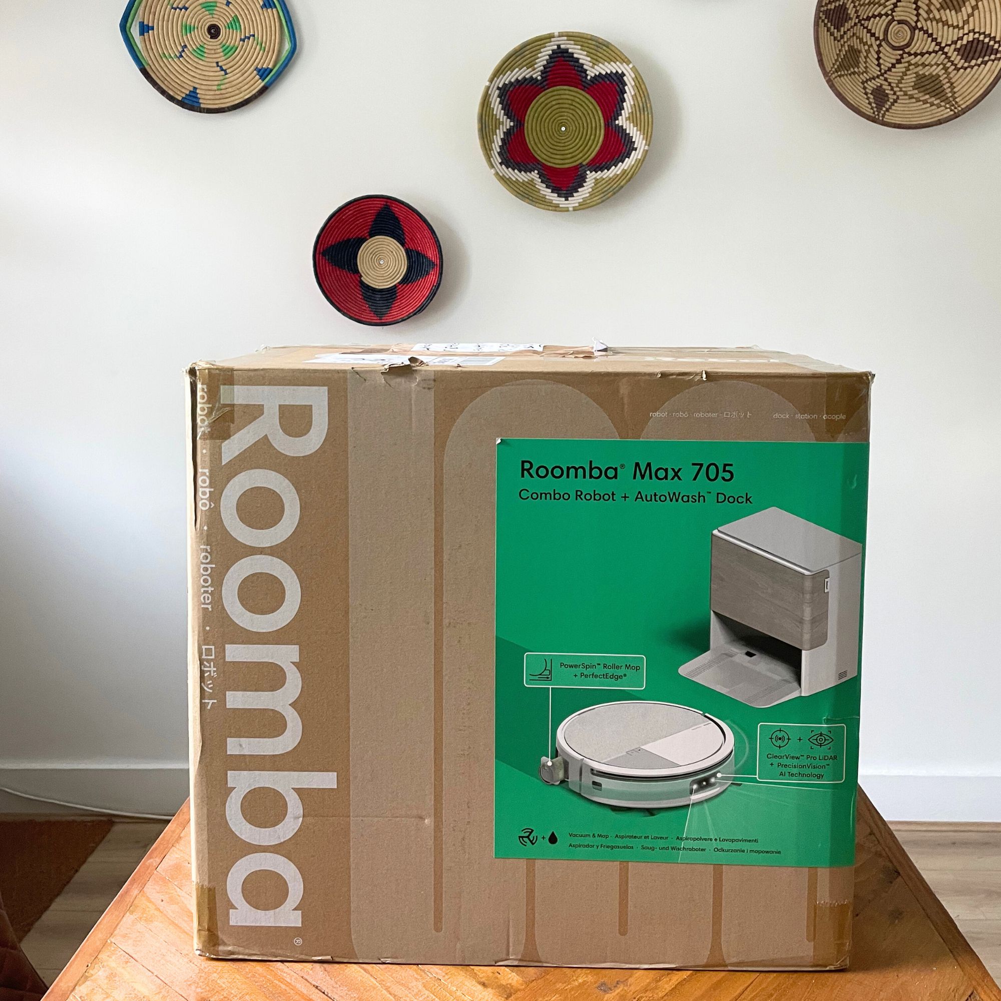 Box of the iRobot Roomba Max 705 Combo Robot Vacuum Cleaner and Mop sitting on a wooden table