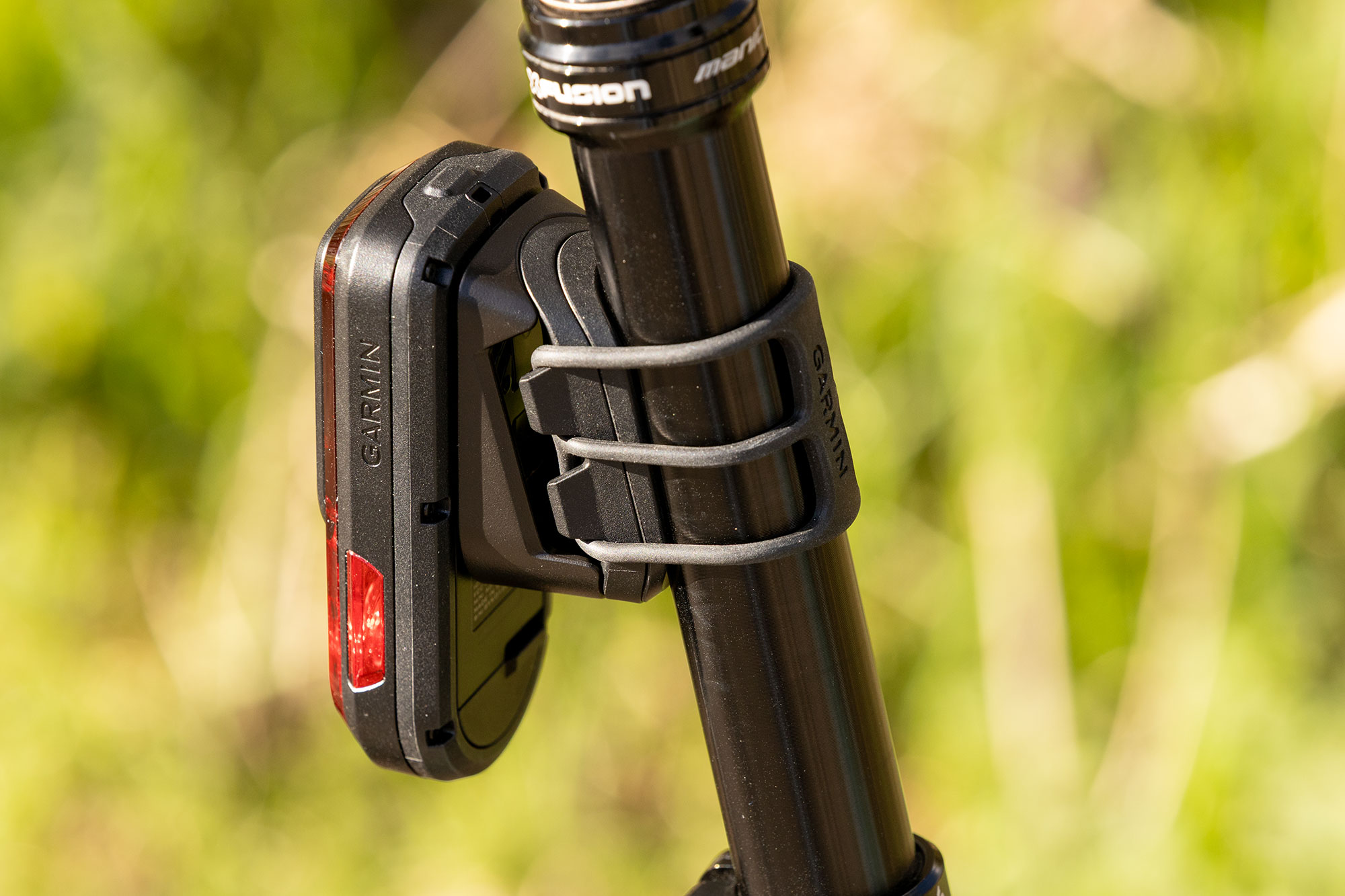 Garmin Varia RearVue 820, mounted on a seat tube, pictured three quarters on from the front. The revised strap is clearly shown.