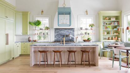 Lime green kitchen with white walls and a wooden island