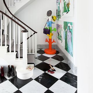 hallway with chequered tiles and stairs