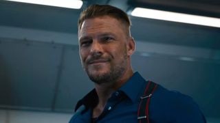 A screen shot of Alan Ritchson as Aimes with a slight smile in Fast X.