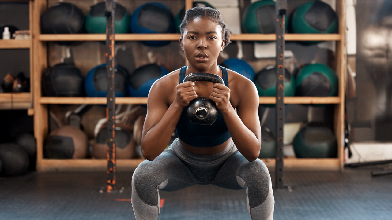 Woman doing a kettlebell squat