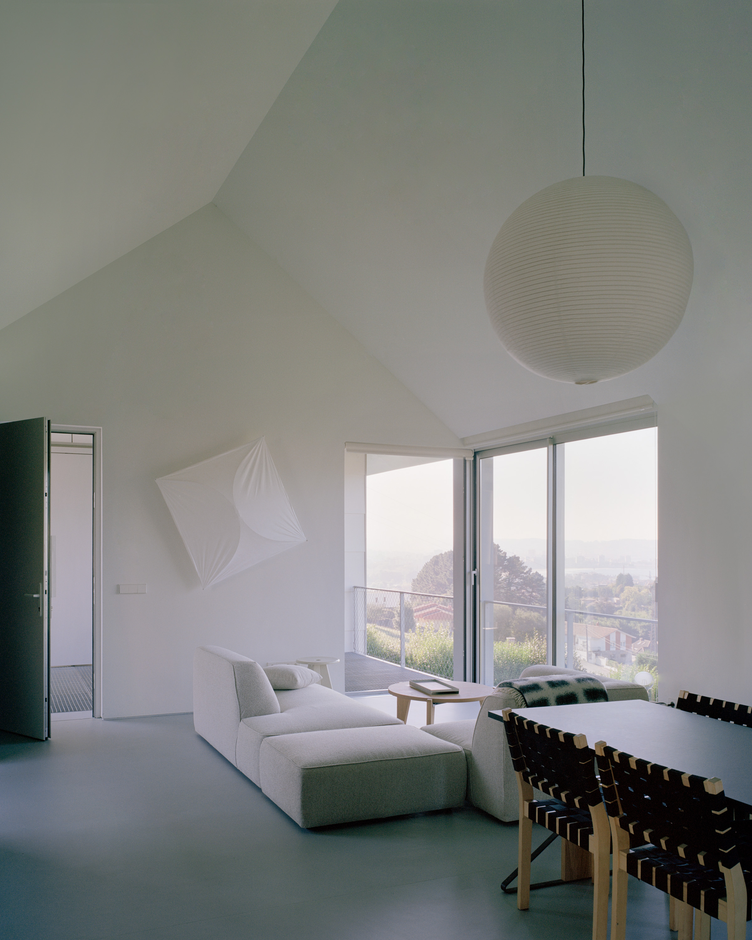 view of minimalist Casa Guadalupe by studio hanghar, a white house with dark timber accents