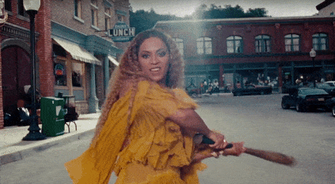 Beyonce hitting the camera with a baseball bat