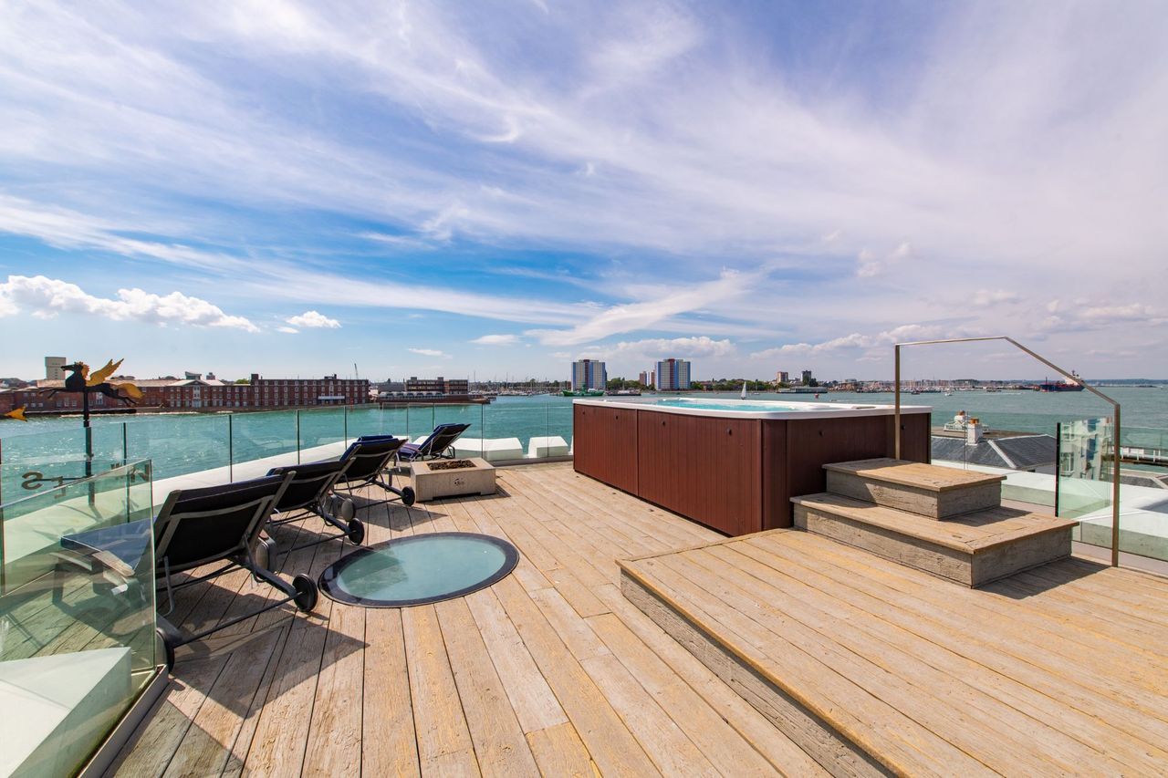 The roof has deck chairs and a hot tub with views overlooking the sea