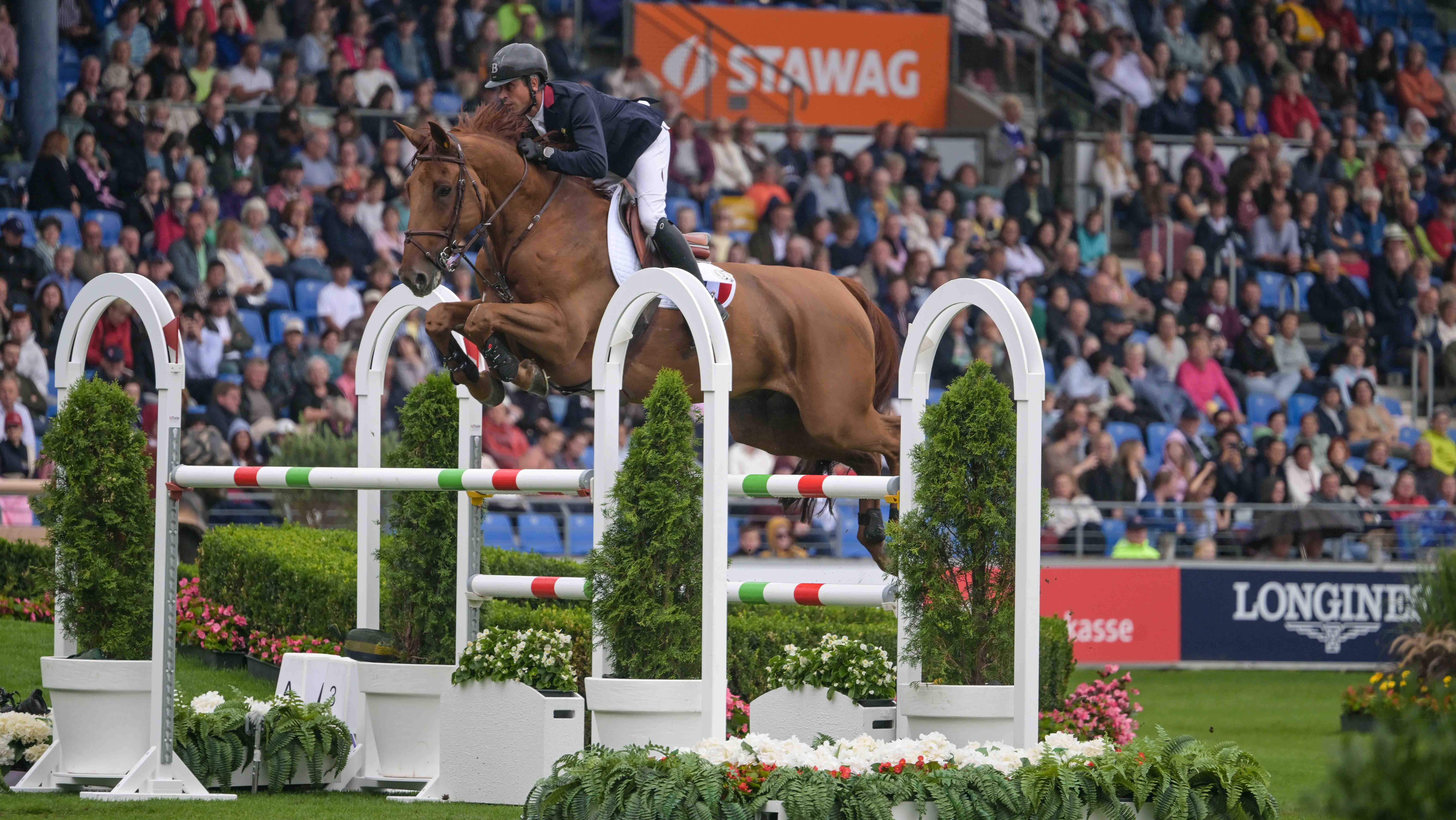 Julien Epaillard and Fringan De Vesquerie jump a spread fence made of white, green and red poles as they top the showjumping World Championships speed leg results in Aachen