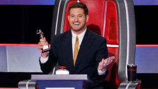 Michael Buble holds a "Woman Power" trophy on The Voice Season 27.