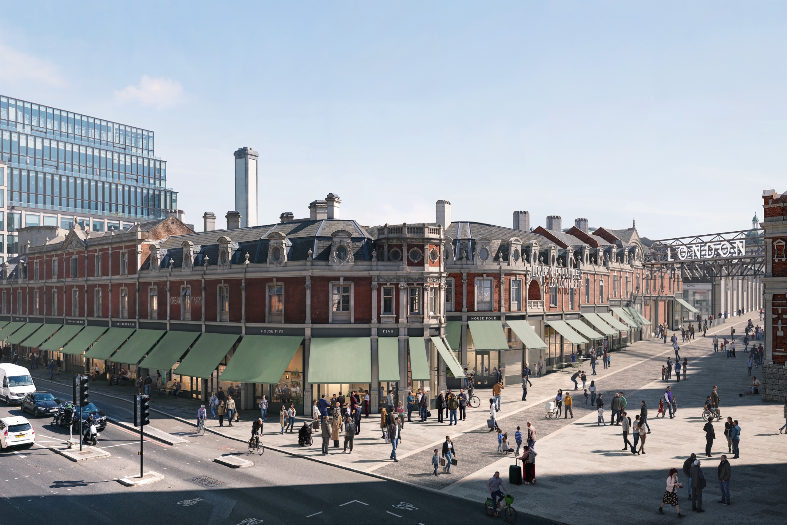 Sun-filled view of an historical red brick building with black ceilings and mint green awnings, surrounded by people strolling alongside cars and shopfronts.