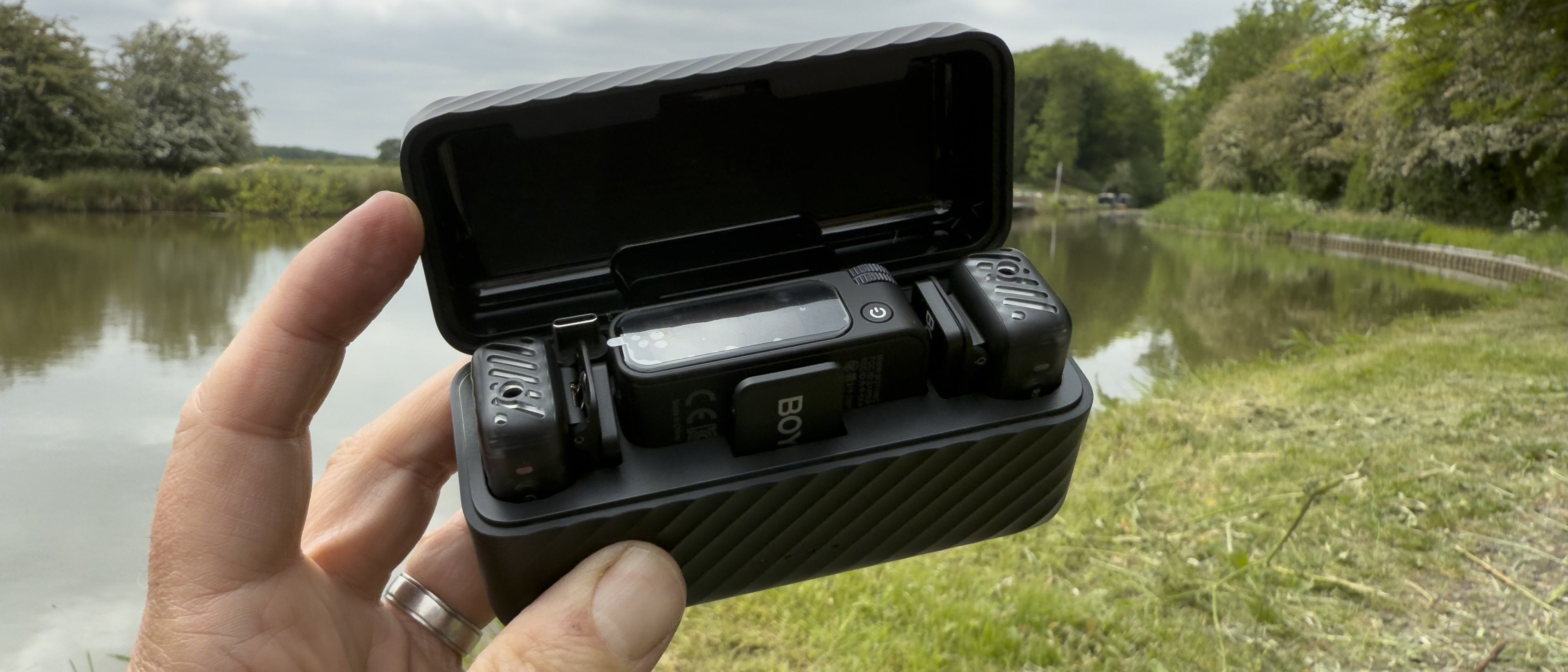 Shot of the plastic carry case with the lid opened to reveal two mics and a receiver