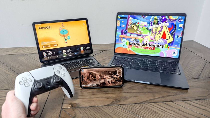 iPhone, iPad on Magic Keyboard and MacBook Air on table showing Apple Arcade games with hand holding PS5 DualSense Controller 