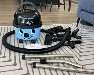 blue vacuum cleaner being tested on floors