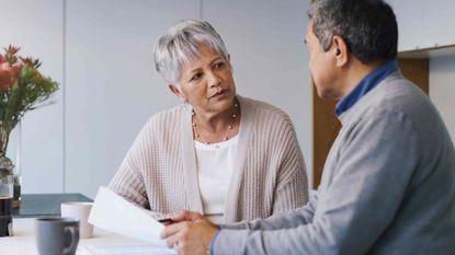 Senior couple talking about finances over documents