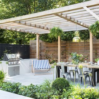 Wooden pergola covering an alfresco seating and cooking area
