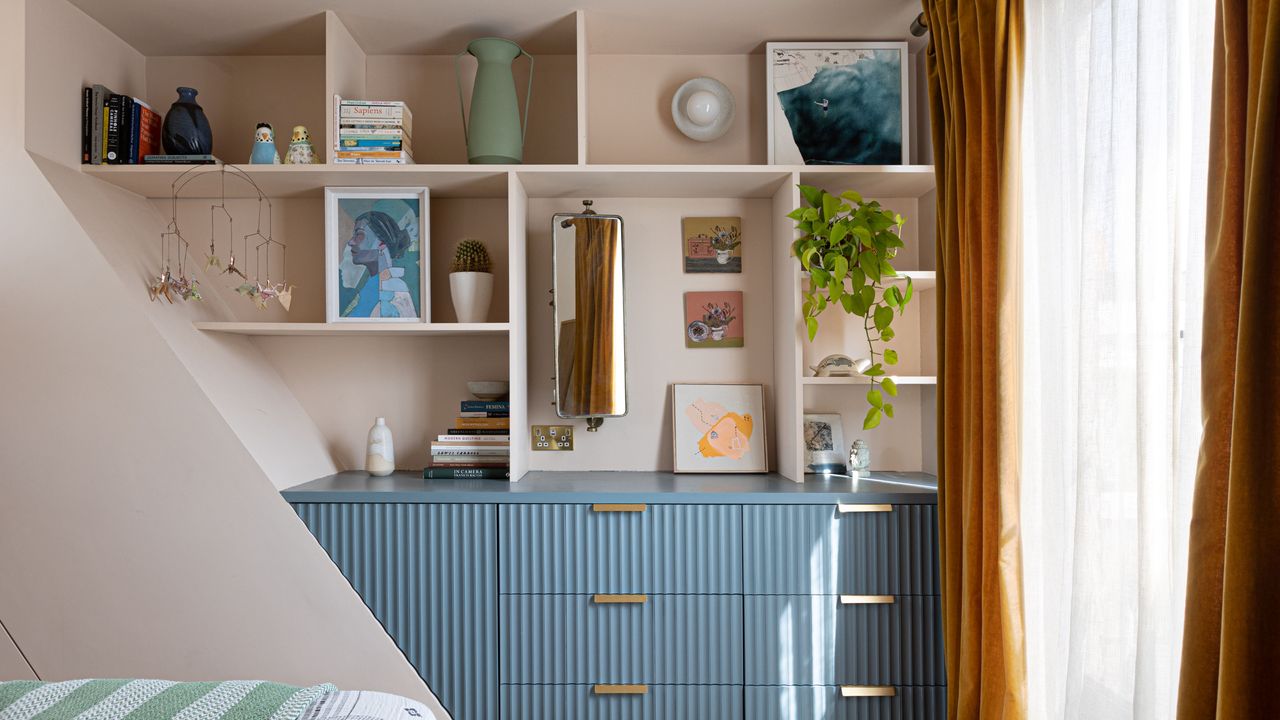 Blue fluted dressers in bedroom alcove, decorated with personal items and home decor