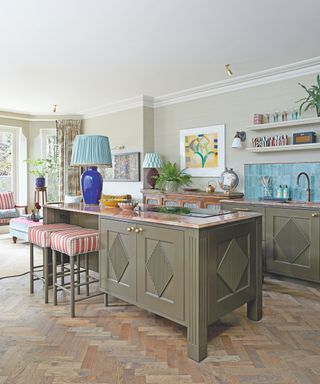 kitchen with green cabinets and wooden floors and blue tiles