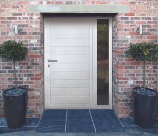 an aluminium front door with a sidelight