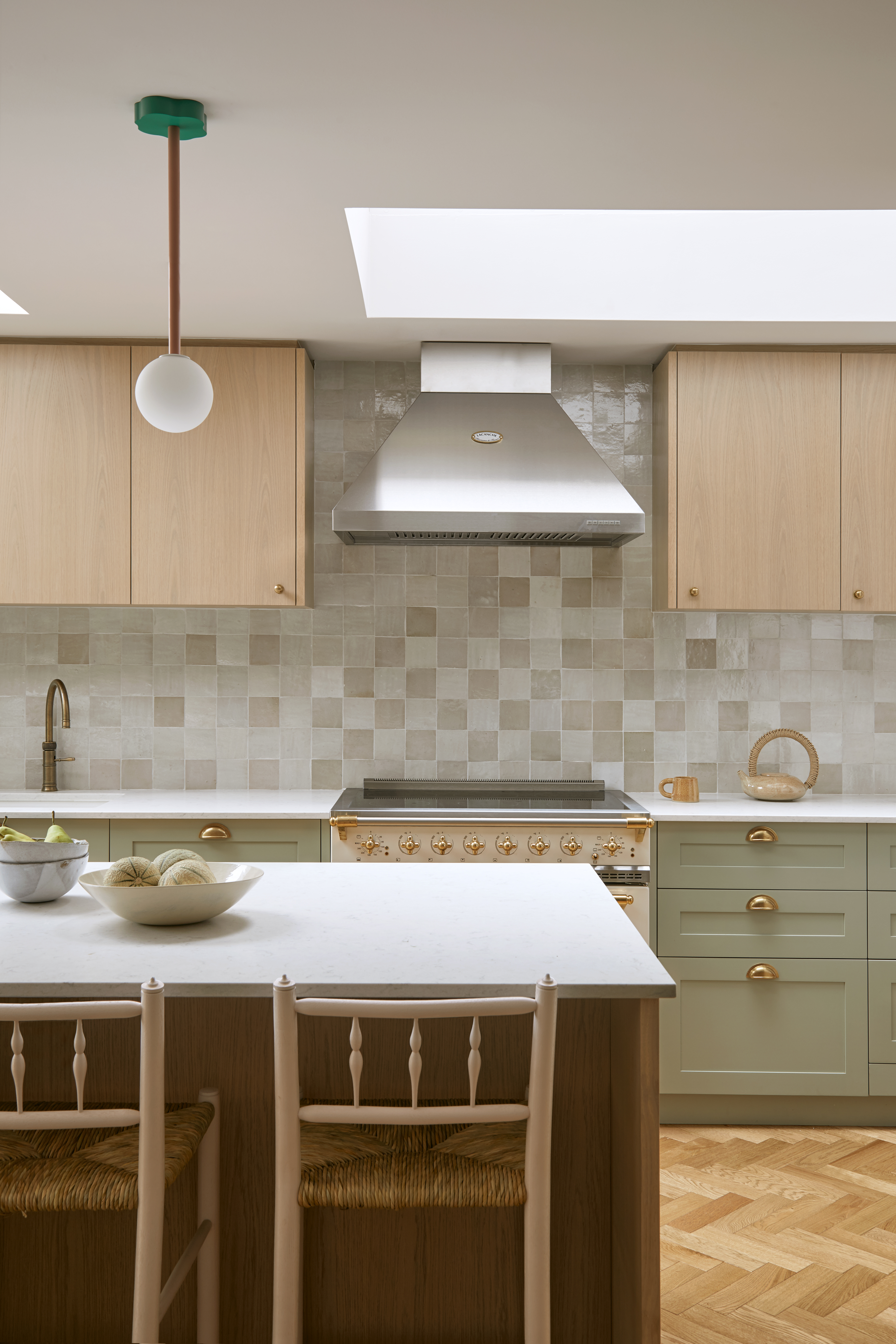 bright modern kitchen with light neutral zellige tiles on the walls
