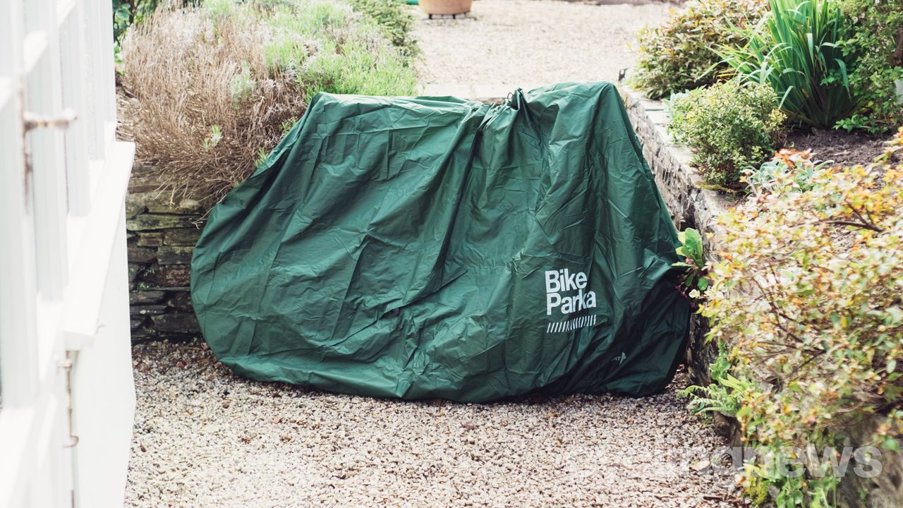A bike covered in a green bike cover