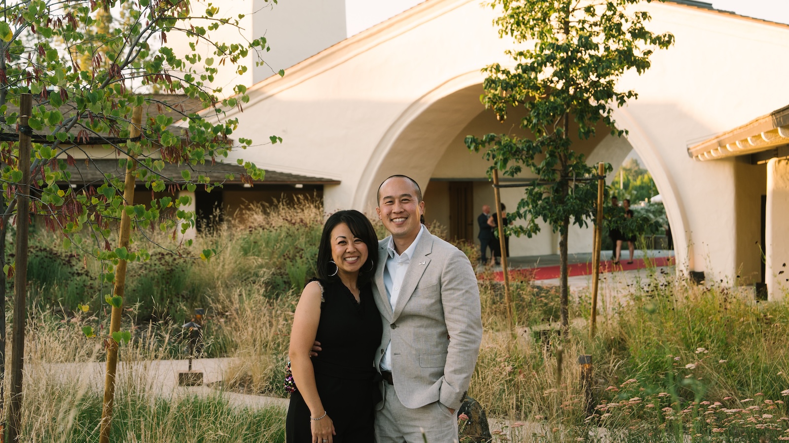Robert Mondavi winemaker Kurtis Ogasawara with his wife in front of the winery's signature archway.