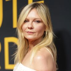 Kirsten Dunst wears an off-the-shoulder white dress