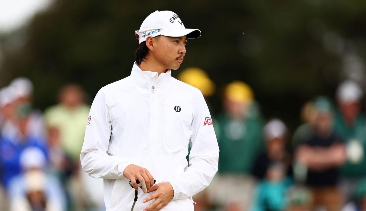 Min Woo Lee looks on whilst holding his putter on the green