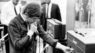 Jack Bruce of the rock band "Cream" records harmonica at the "Strange Brew" recording session at Atlantic Recording Studios on April 5, 1967 in New York City, New York.