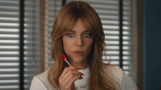 Morgan wide-eyed and holding a lollipop inside the police station in High Potential Season 2