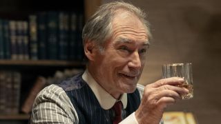 Donald Whitfield holding glass of whiskey in 1923 Season 2