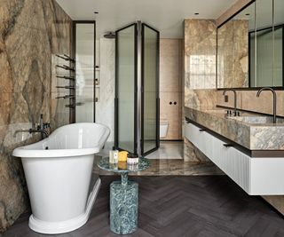 bathroom with parquet floor and modern roll top and marble vanity