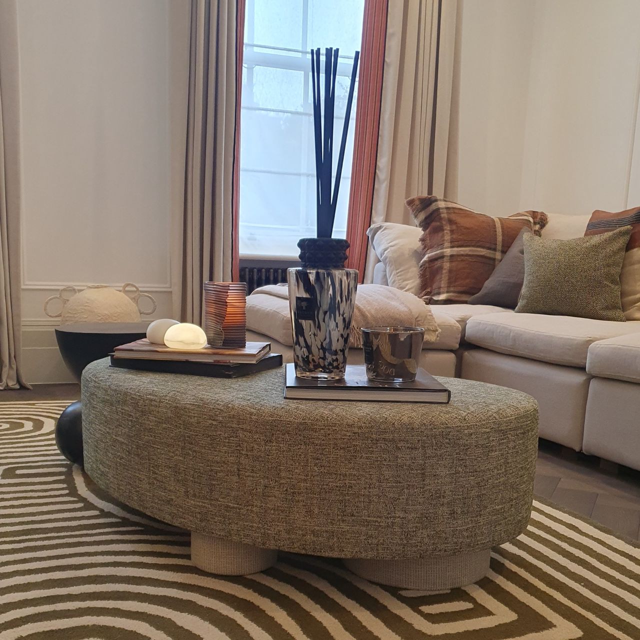 A large Baobab reed diffuser on a living room ottoman at the Sofa.com townhouse in London's Chelsea