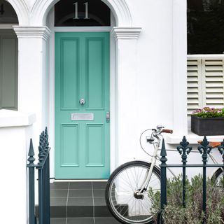 front door colour mistakes, aqua green front door with chrome hardware, white painted exterior