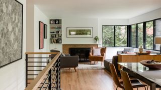 The living room are of a treehouse-like home surrounded by Olmstead-designed park