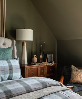 bedroom with olive walls and plaid bedlinen