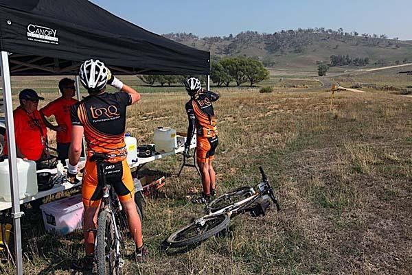 Luke and Paul pass through a feed station on Stage 1 of the Terra Australis MTB Epic